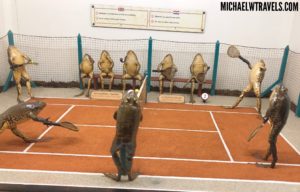 a group of statues on a tennis court