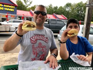 a man and boy eating burgers