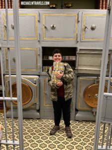 a boy holding a book in a locker room