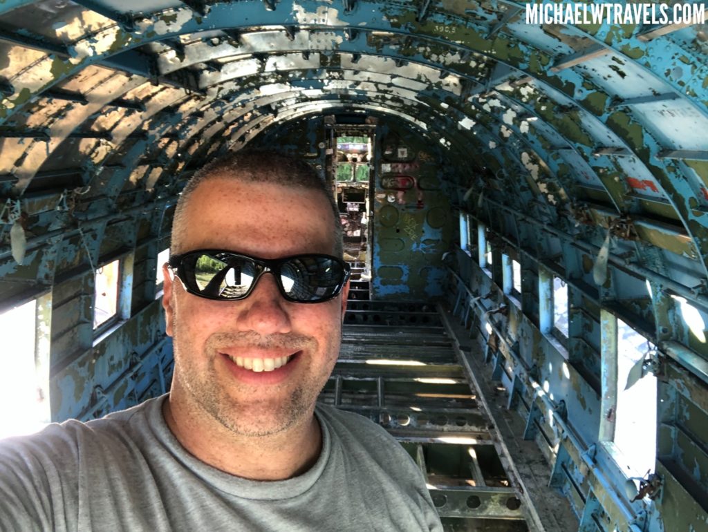 a man taking a selfie in an old plane