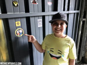a boy pointing at a sticker