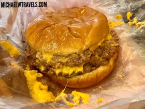 a cheeseburger on a plastic wrapper