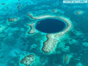 a blue hole in the ocean with Great Blue Hole in the background