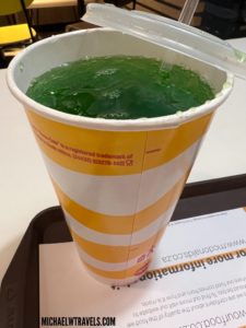 a cup with green liquid in it