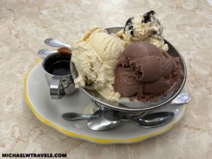 a bowl of ice cream with spoons