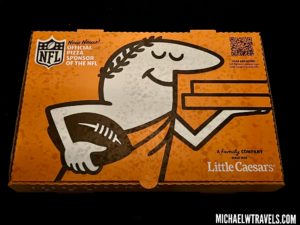 a box of pizza with a cartoon character holding a football