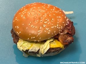 a cheeseburger on a blue surface