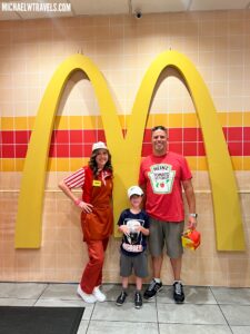 a family posing for a photo in front of a mcdonald's logo