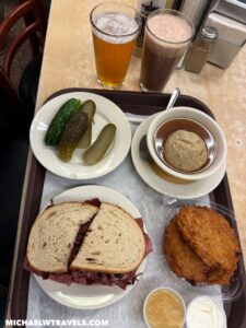 a tray with sandwiches and soup and drinks