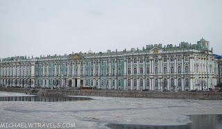 a large building with many windows with Winter Palace in the background
