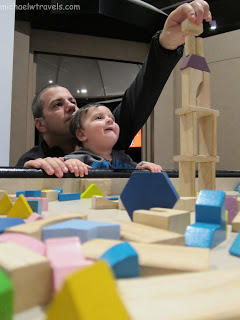 a man and child playing with blocks