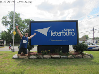 a man posing in front of a large sign