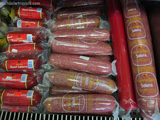 a shelf of sausages in plastic bags