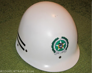 a white helmet with a green emblem