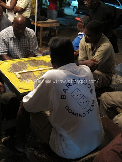 a group of people playing dominoes
