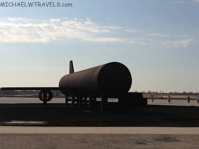 a large black tank on a runway