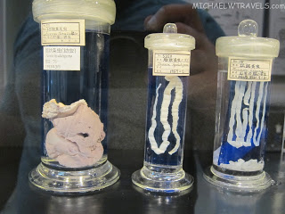 several glass containers with liquid and white objects