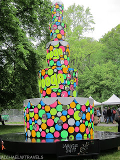 a large multi-tiered cake with colorful circles and letters