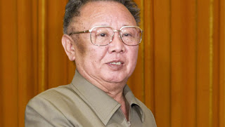 a man wearing glasses and a green shirt