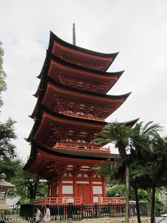 a tall pagoda with a cross on top