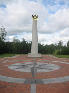 a tall white pillar with gold stars on top