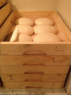 a wooden box with white round objects in it
