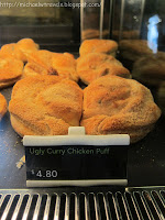 a display case with chicken puffs