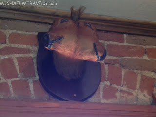 a horse head on a brick wall