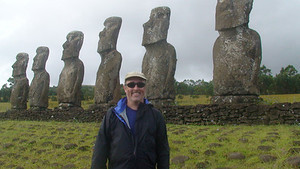 a man standing in front of a group of statues