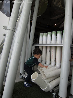 a child climbing a pipe structure