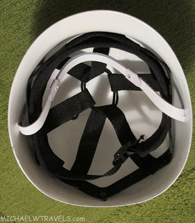 a white helmet with straps in it