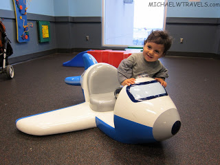 a child on a toy plane