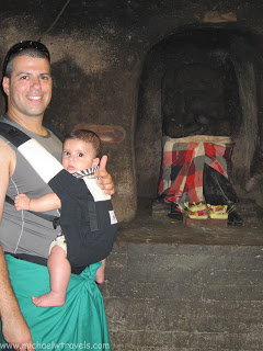 a man holding a baby in a carrier