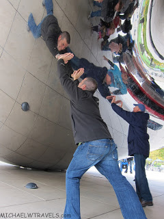 a group of men climbing a large reflective surface