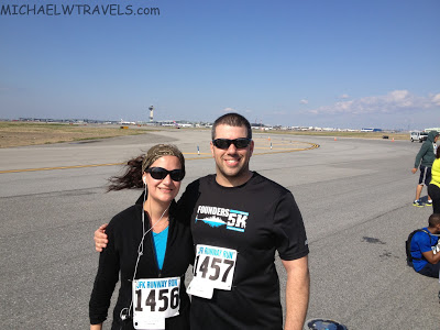 a man and woman standing on a runway
