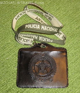 a black badge with a white and green lanyard