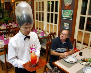 a waiter serving drinks at a restaurant