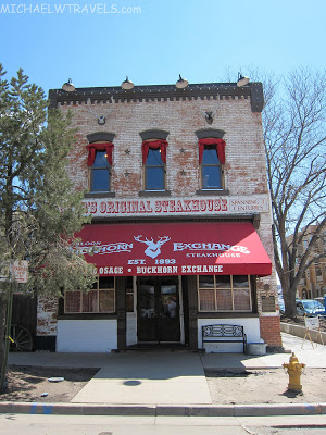 a brick building with a red awning