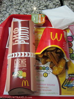 a fast food container and french fries on a tray