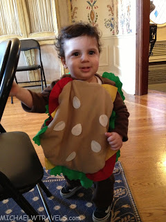 a child wearing a hamburger garment
