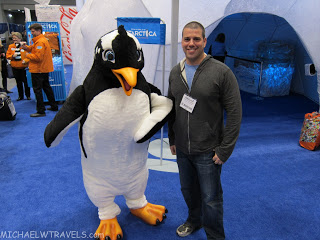 a man standing next to a penguin garment