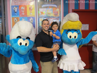 a man holding a child in front of a group of blue and white characters