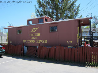 a red train car with yellow writing