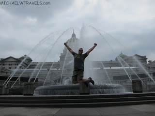 a man jumping in front of a fountain