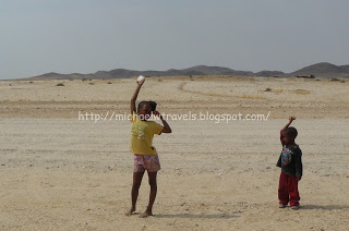a group of children playing in the desert