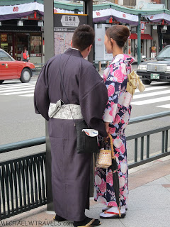 a man and woman standing on a sidewalk