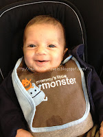 a baby smiling with a bib