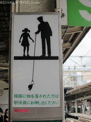 a sign with a man and a girl on a leash