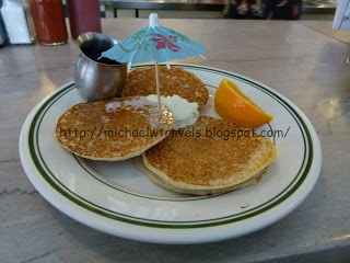 a plate of pancakes with an umbrella and a small umbrella
