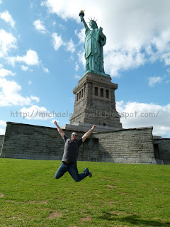 a man jumping in the air in front of a statue